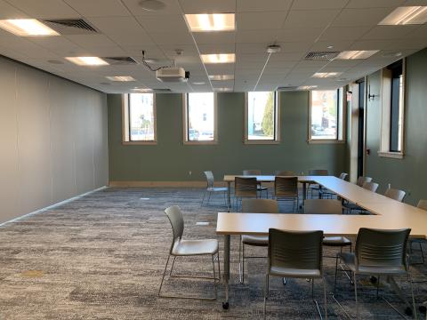 Example room setup with tables and chairs in front of the room divider to the left.