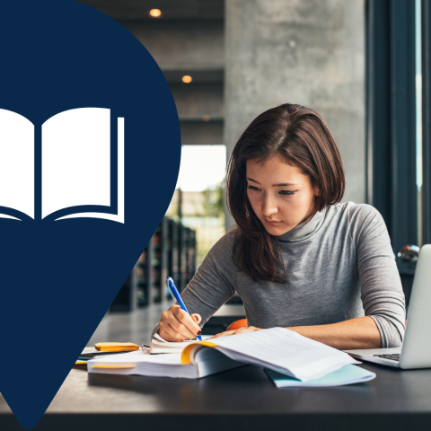 A picture of someone doing research in a library.